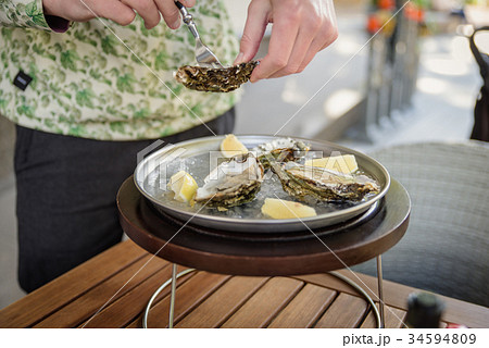 man prepares to eat oyster 34594809