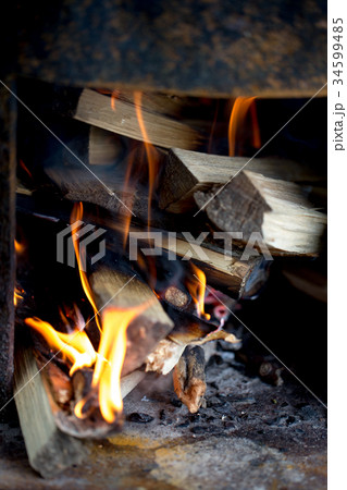 Burning wood in the fireplace 34599485