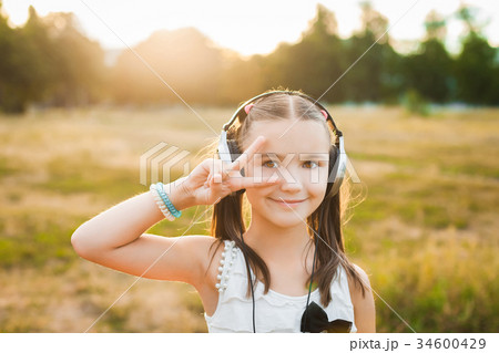 cute girl listening music and dancing 34600429
