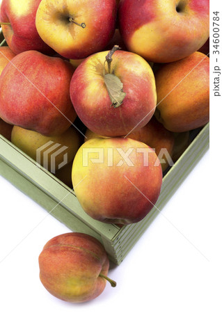Fragment of a box with ripe apples on a white 34600784