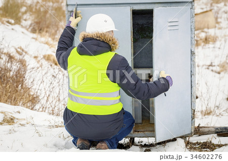 Railroad worker checking electrical enclosures 34602276