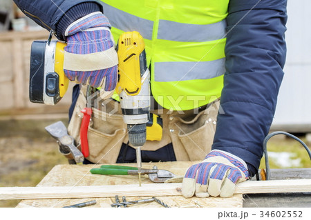 Worker using drill Worker using drill 34602552