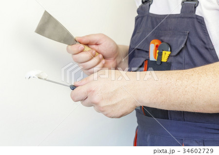 Worker with spatula near wall 34602729