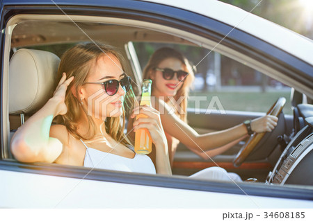 The young women in the car smiling 34608185