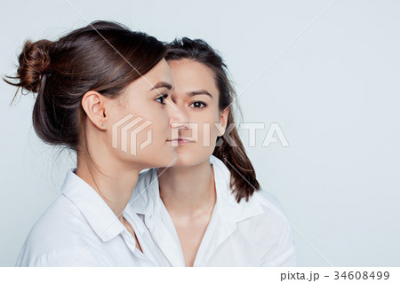 Studio portrait of female twins Studio portrait of female twins 34608499
