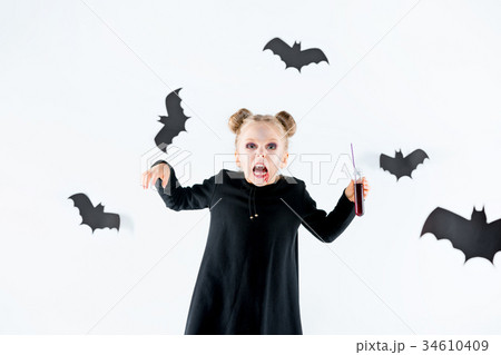 Little girl witch in black dress over magical 34610409
