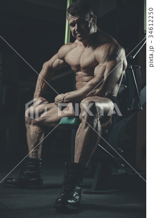 Brutal Caucasian bodybuilder working out in gym Brutal Caucasian bodybuilder working out in gym 34612250