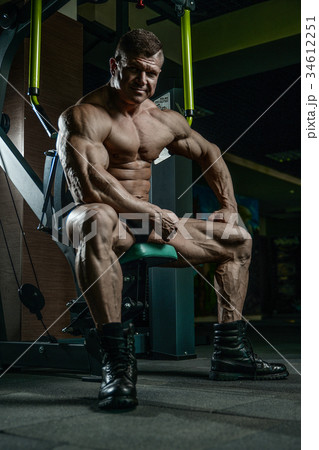 Brutal Caucasian bodybuilder working out in gym 34612251