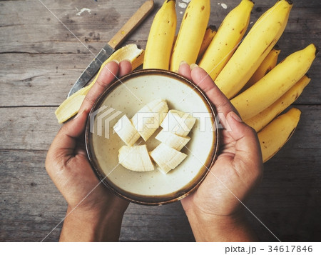 Banana slices on hands 34617846