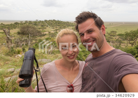 Adult couple taking selfie on african wildlife Adult couple taking selfie on african wildlife 34620929