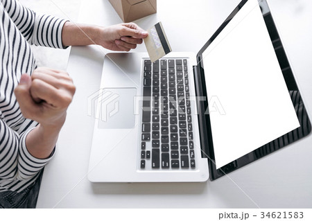 Woman's hands using credit card register and payments online sho Woman's hands using credit card register and payments online sho 34621583