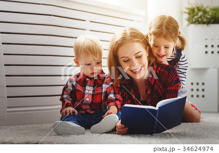 Mother reads book to children 34624974
