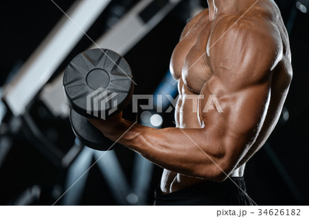 Handsome model young man working out in gym 34626182