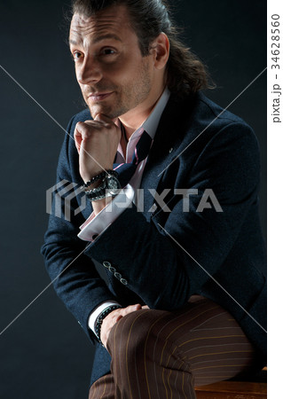 Businessman sitting on an armchair Businessman sitting on an armchair 34628560