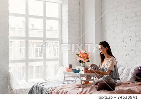 Thoughtful woman with cup of coffee in the morning 34630941