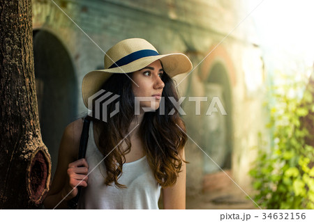 Girl with hat on summer day in the street. Girl with hat on summer day in the street. 34632156