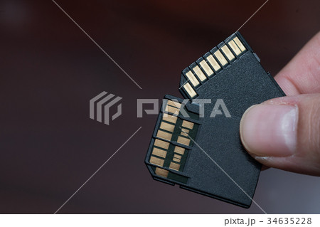 hand holding sd card uhs i and uhs ii hand holding sd card uhs i and uhs ii 34635228