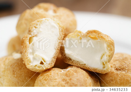 profiteroles on plate closeup one sliced profiteroles on plate closeup one sliced 34635233