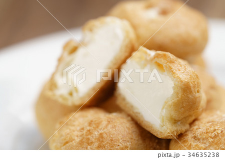 profiteroles on plate closeup one sliced profiteroles on plate closeup one sliced 34635238
