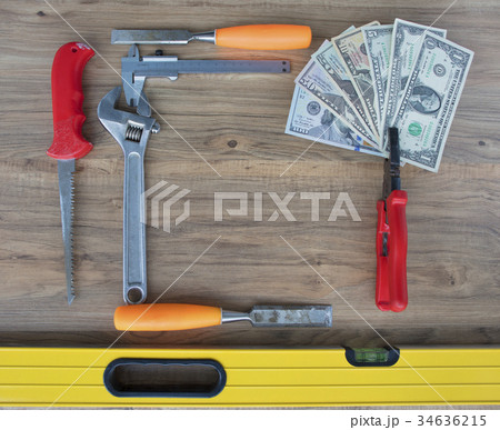 Old construction tools and a set of dollar bills Old construction tools and a set of dollar bills 34636215