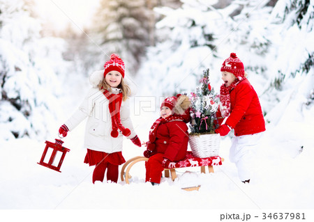 Children with Christmas tree. Snow winter fun 34637981