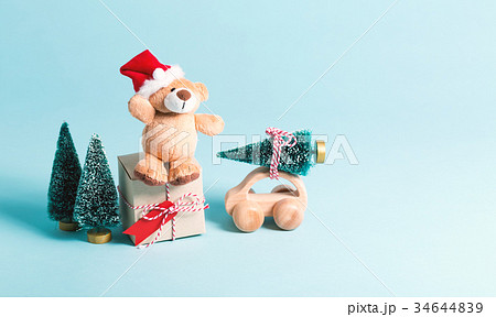 Teddy bear in a Santa hat with a gift box and Teddy bear in a Santa hat with a gift box and 34644839