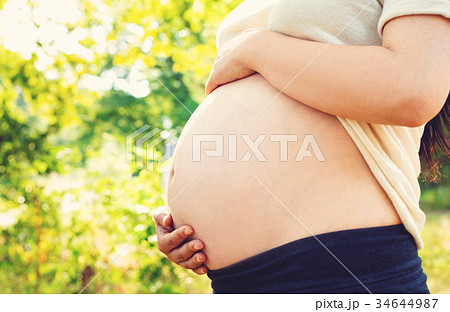 Pregnant woman outside 34644987