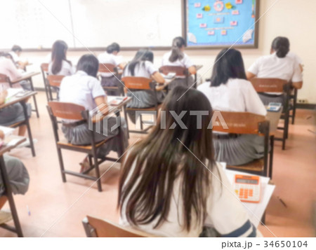 Blur students doing exam in classroom 34650104