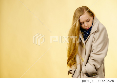 Woman wearing autumnal beige coat Woman wearing autumnal beige coat 34653526