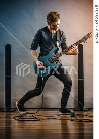 Young man playing electric guitar Young man playing electric guitar 34653529