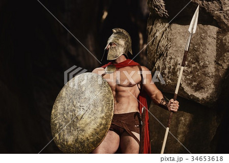 Powerful gladiator posing on rocks  34653618