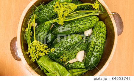 Making pickled cucumbers in clay jar Making pickled cucumbers in clay jar 34653742