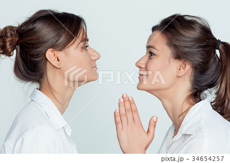 Studio portrait of female twins Studio portrait of female twins 34654257