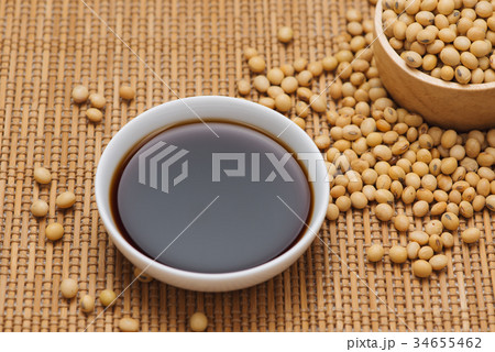 Soy sauce and soy bean on wooden table 34655462