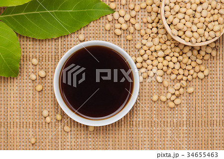 Soy sauce and soy bean on wooden table Soy sauce and soy bean on wooden table 34655463