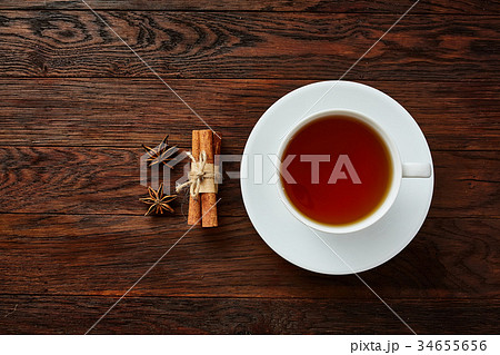 A cup of tea on a rustic wooden board, top view 34655656