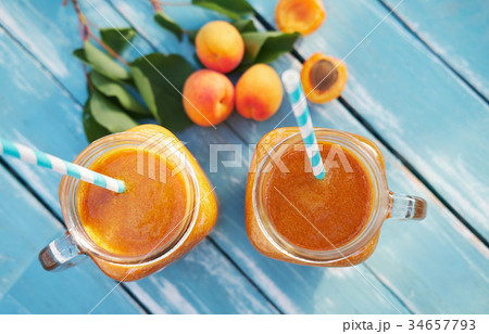 Two glasses of fresh apricot smoothie Two glasses of fresh apricot smoothie 34657793