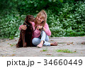 smiling girl relaxing with dog.Labrador sitting 34660449