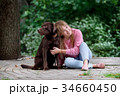 smiling girl relaxing with dog.Labrador sitting 34660450