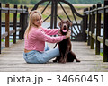 blonde girl smiling with dog Labrador. 34660451