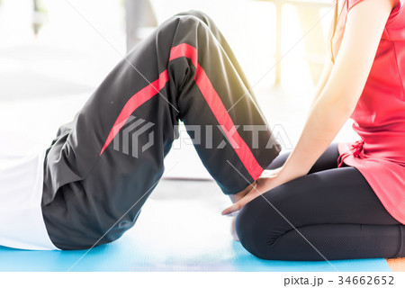 Young man exercising sit-ups Young man exercising sit-ups 34662652