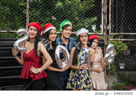 Young people holding glass talk in the party. 34665009