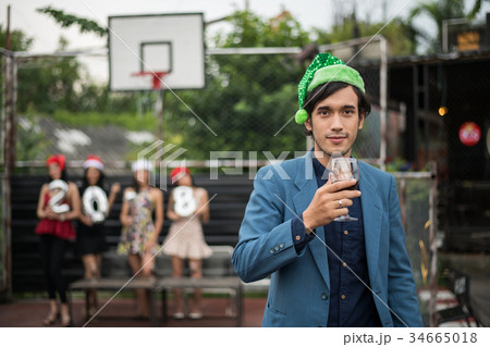 Young people holding glass talk in the party. 34665018