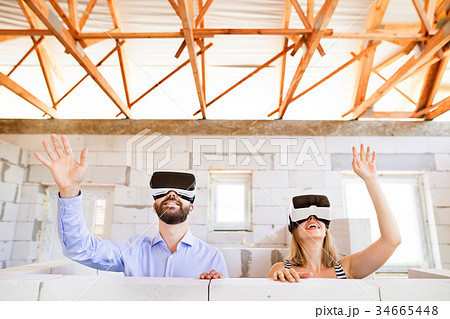 Young married couple at the construction site. 34665448