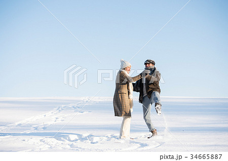 Beautiful senior couple on a walk in sunny winter Beautiful senior couple on a walk in sunny winter 34665887
