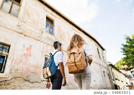 Two young tourists with backpacks in the old town. 34665921