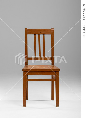 Simple old used wooden chair in empty room on gradient gray background 34666614