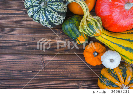 Pumpkins on wooden background 34668231