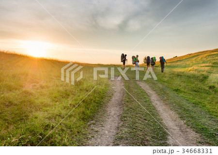 Group of hiking friends in the sunset mountains 34668331