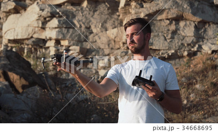 Man getting drone from flight Man getting drone from flight 34668695